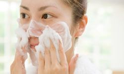 woman washing her face