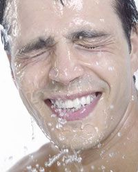 man with wet face smiling