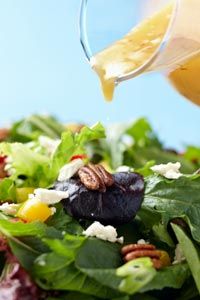 pouring dressing on salad