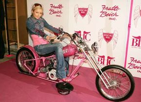 Paris Hilton poses on her $250,000 custom chopper.