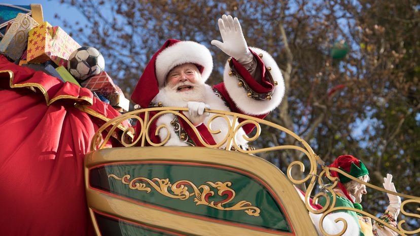 Santa waves to parade goers.