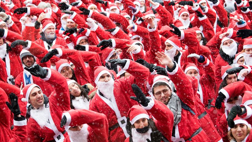 Over 1,000 people dressed in Santa Claus costumes prepare for a run.