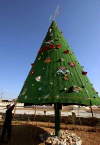 An Iraqi decorates a Christmas tree in the northern Iraqi city of Arbil on Dec. 21, 2006.