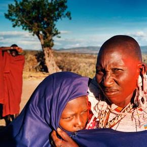 After this girl’s circumcision in November 2004, she is shown to neighbors to prove the surgery was successful. In the background is her future husband. She will be married immediately after her healing period is over.
