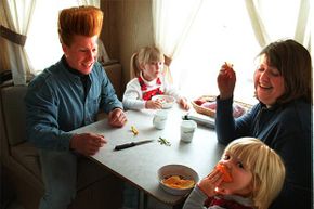 Big Apple Circus clown Bello Nock dines with his wife Jenny and their two daughters in their trailer.