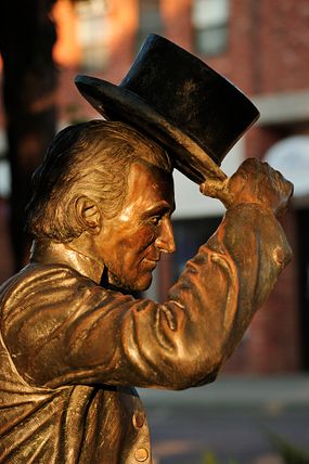 statue of james monroe lifting hat