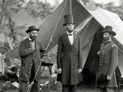 President Abraham Lincoln (center) visits the Union camp with Major Allan Pinkerton (his bodyguard and head of Union Intelligence) and General John McCleland.