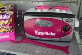 The current Easy-Bake Oven bears little resemblance to the model with the cooktop and front-loading oven that caught so many little fingers.