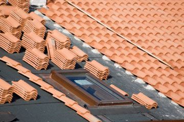 Clay roof tile installation on a home