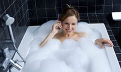 Woman bathing with cell phone. 