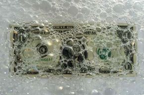 dollar bill under sudsy water