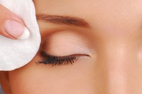 cleaning woman face with cotton pads. Cosmetic treatment.