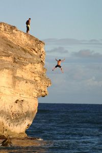 Person daringly ventures outdoors for extreme cliff adventure.