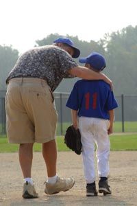 dad and son at baseball field