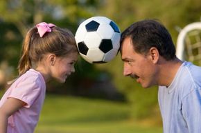 dad and daughter with soccer ball