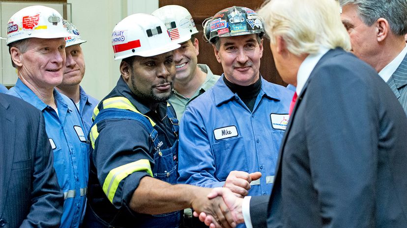 Coal miners shake hands with U.S. President Donald Trump on Feb. 16, 2017, before he repealed a rule enacted by President Barack Obama to protect waterways from coal mining waste. Ron Sachs-Pool/Getty Images
