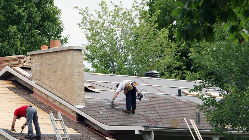 men repairing roof