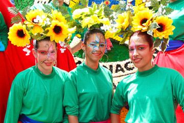 young women wearing flowers and face paint