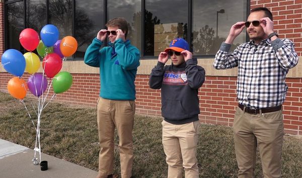 Austin Mitchell-Goering, Noah Vittengl and Ryan January try on the glasses at Brill Eye Center in Mission, Kan. ()