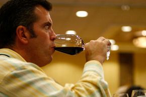 A guest tries some wine at a Colorado wine festival.