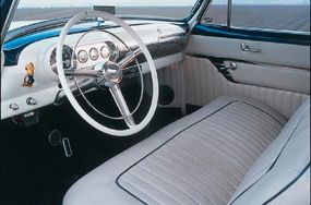 The interior was finished with pearl-whitetuck-and-roll upholstery with blue piping.