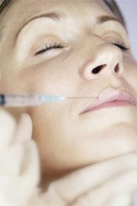 Woman receiving lip injection.