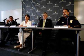 University of Colorado Anschutz Medical Campus Dean of the Graduate School Barry Shur (left), Executive Vice Chancellor Lilly Marks, Chancellor Don Elliman and Police Chief Doug Abraham speak during a 2012 news conference in Aurora, Colo.
