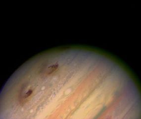 Here is a Hubble Space Telescope image of Jupiter after pieces of comet Shoemaker-Levy 9 hit the planet. The dark spots are the impact sites.