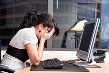 distressed woman in front of computer