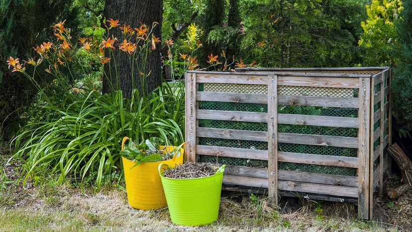 A DIY compost bin made of wooden boards.