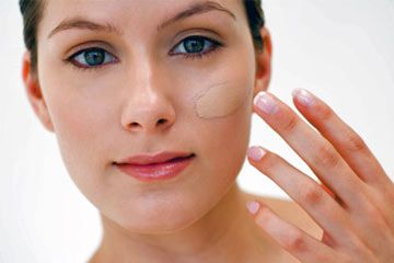 woman applying concealer