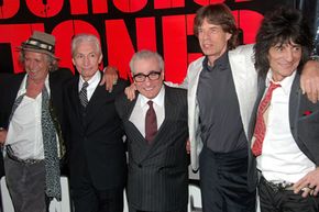 乐队需要考虑其他选项除了简单的旅行。The Rolling Stones, shown here with director Martin Scorcese, made a bang with its concert movie, "Shine a Light."”width=