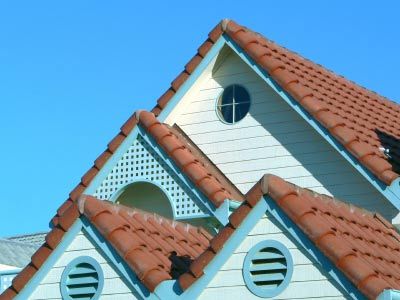 A study in terracotta blue and white. Spanish roof tiles on a wood clad house