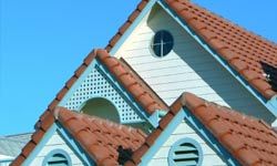 A study in terracotta blue and white. Spanish roof tiles on a wood clad house