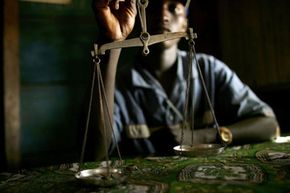 A gold merchant in Bunia in the Democratic Republic of the Congo, where many mines are under the control of violent militias, rebels and other armed groups.