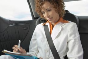 Woman writing in car