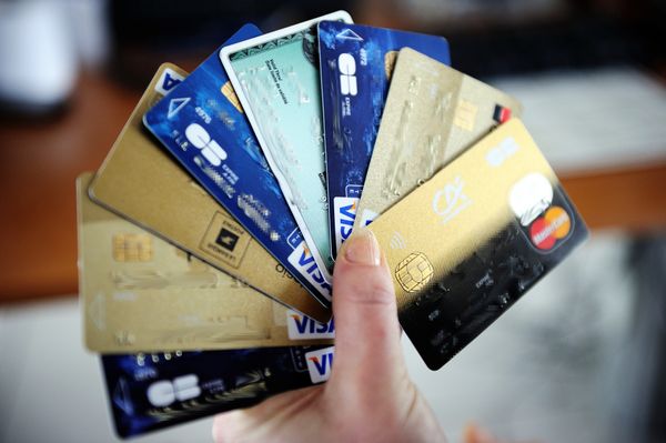 A person holds credit cards.