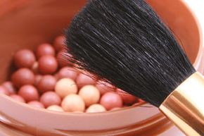 Cosmetic bronzer with brush