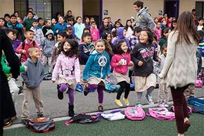 The entire student body at Rocketship SI Se Puede charter elementary school dances during 'launch,' the all-school morning program, in San Jose, California in 2014. See school lunch pictures.