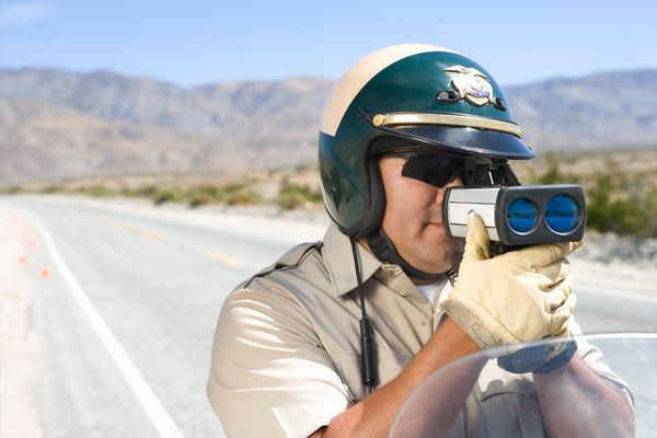 Police officer using speed gun