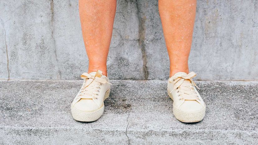 woman's feet on cracked pavement