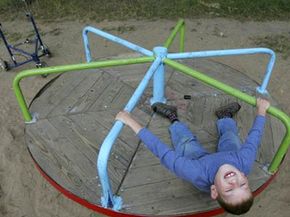 A child with cerebral palsy playing on a merry-go-round at a boarding school south of Minsk, Belarus. See more mental disorder pictures.