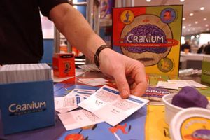 person demonstrating contents of Cranium board game