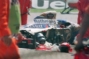 People gather around Ayrton Senna’s crashed car.