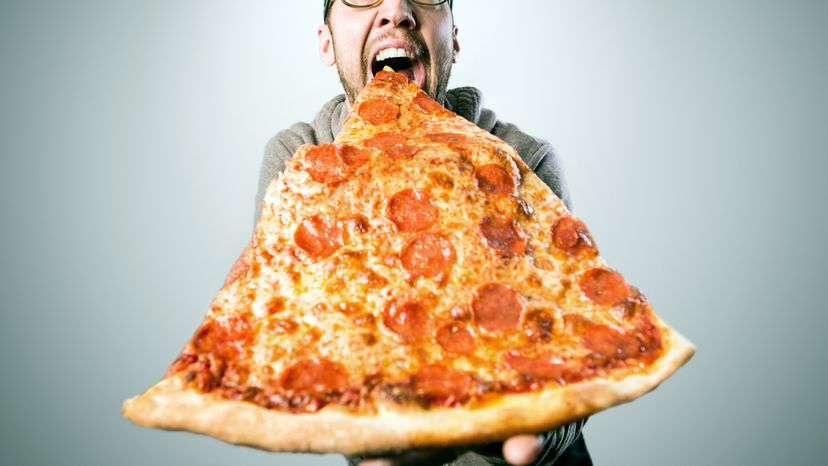 A man with an oversized pizza