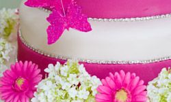 This cake contrasts super-smooth fondant with texture from rhinestones, flowers and a sugary butterfly.