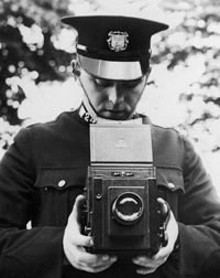 A police officer trains with his new camera in 1935.