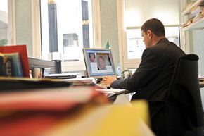 An INTERPOL officer is at work on May 5, 2008 at the Lyon-based agency, eastern France, on images of a man who is thought to be involved in child abuse.