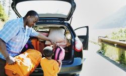 Father and son load car