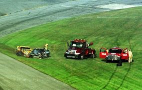The aftermath of the crash that killed Dale Earnhardt, Sr. His car, the black #3, does not appear to be heavily damaged.
